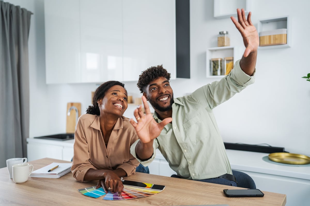 Happy couple reviewing construction plans